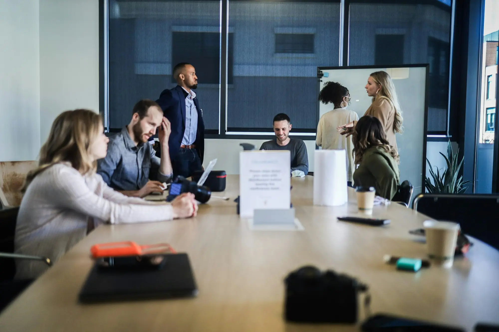 Team meeting around a table reviewing a grant application