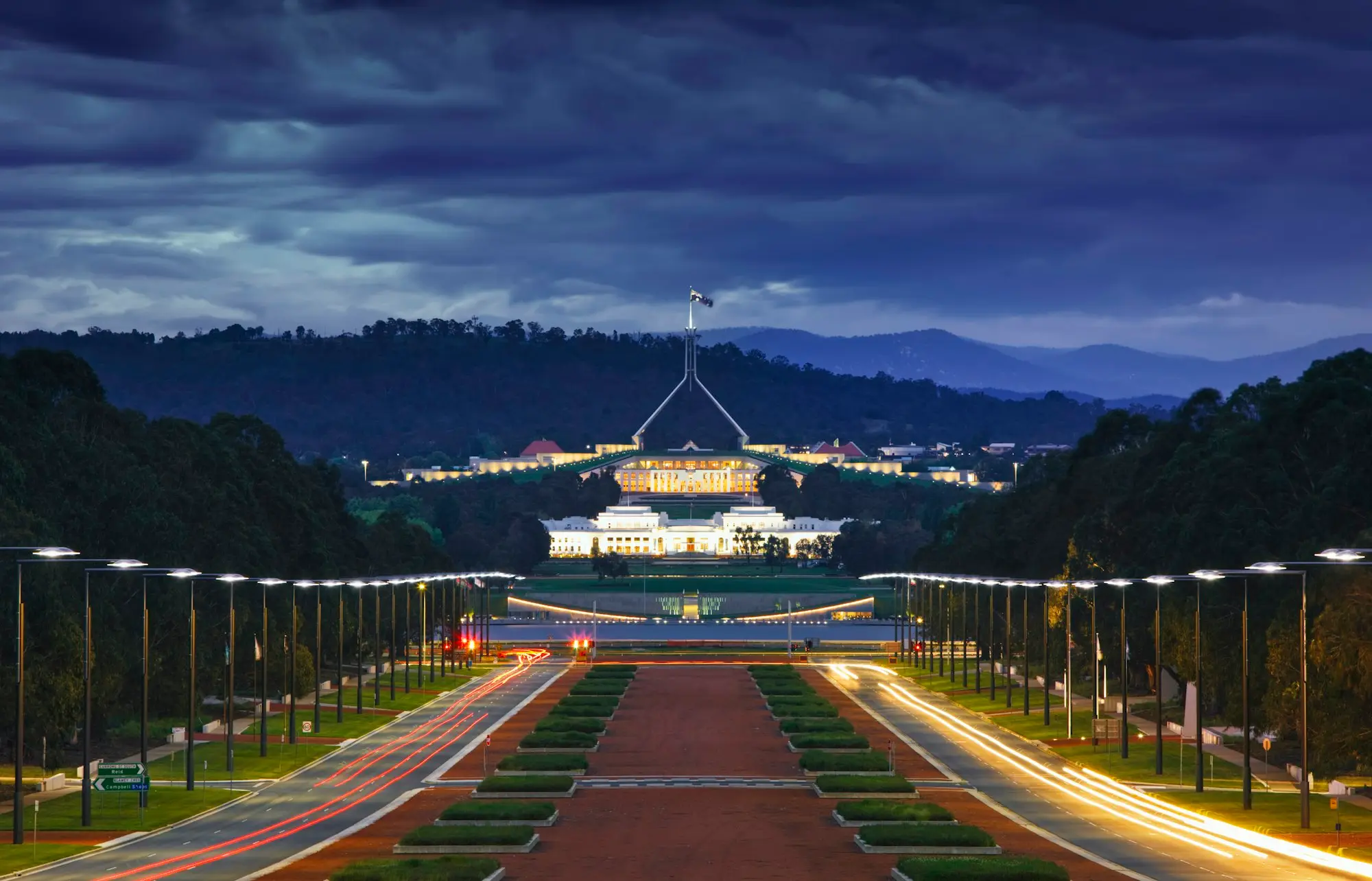 Parliament House, Canberra, lit up at dusk